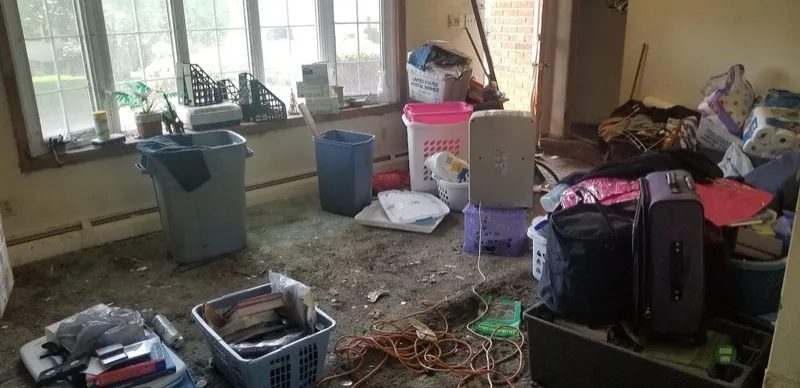 Cluttered room with boxes and bins in an older house