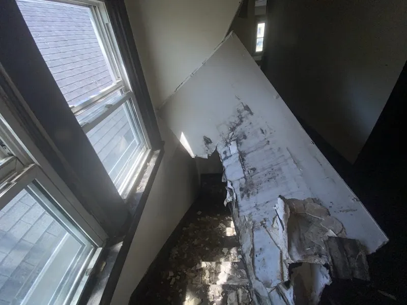 Room with a damaged ceiling and debris