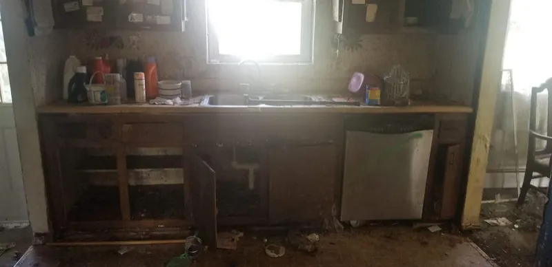 Gutted kitchen with open cabinets