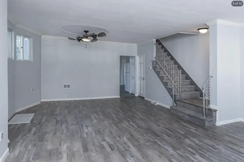 Living room after renovation, with new flooring and fresh paint