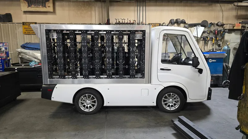 Legion 36 electric mini LED truck parked indoors at a crowded stadium concourse event