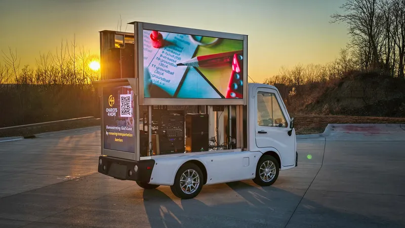 Legion 36 electric mini LED truck displaying an ad at sunset
