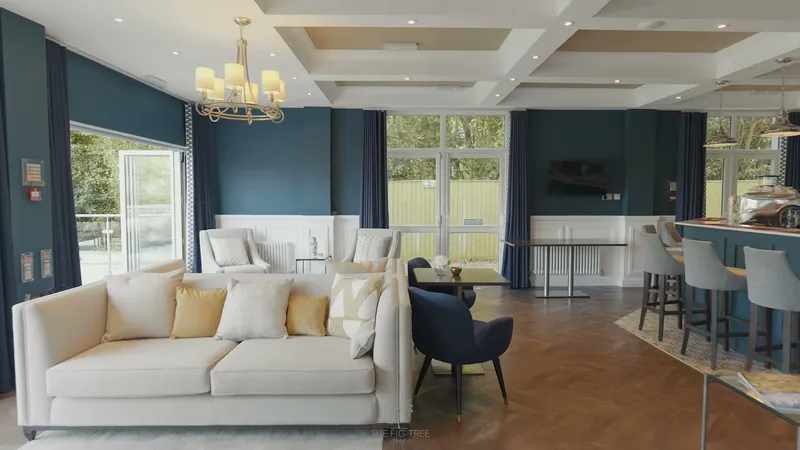 The navy lounge at The Fig Tree, Shanklin, with a coffered ceiling and white sofas