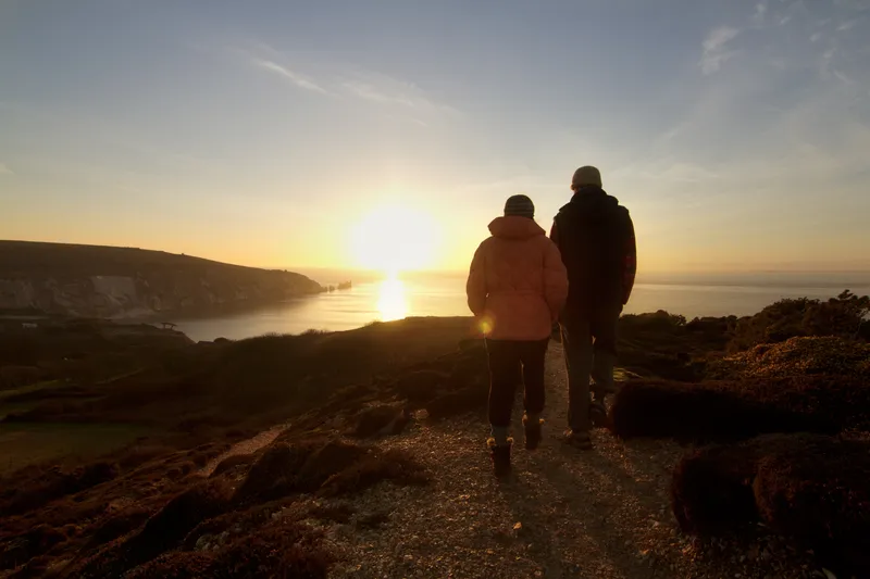 Walkers on an Isle of Wight clifftop above the sea, near Shanklin