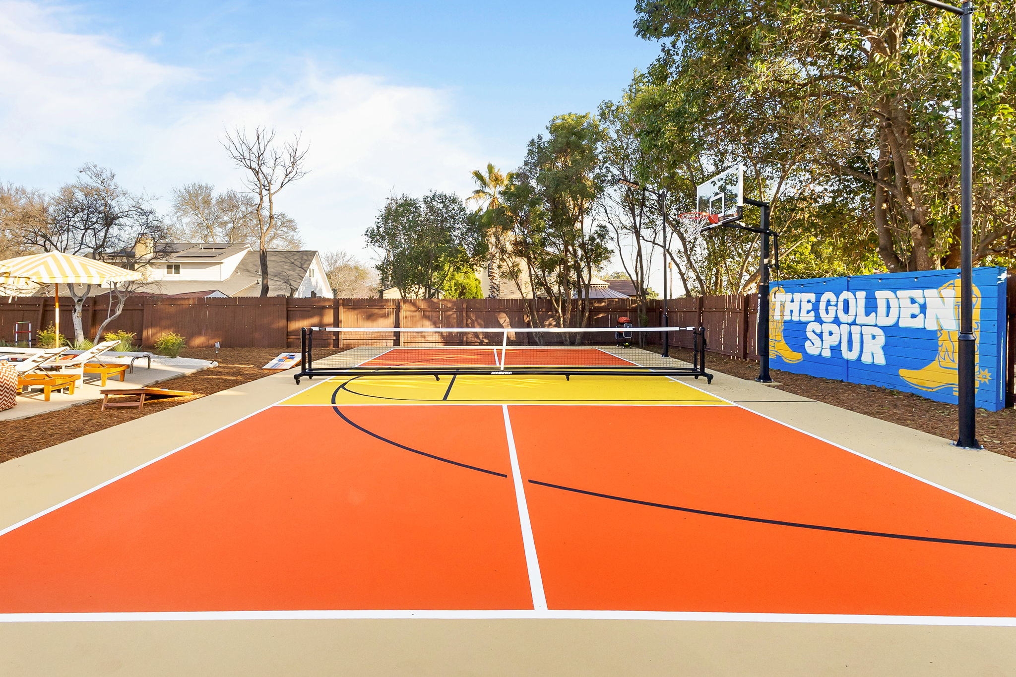 Ground level view of a finished multi-use court with basketball and pickleball striping
