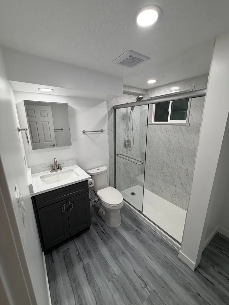 Tub-to-shower conversion with sliding glass doors