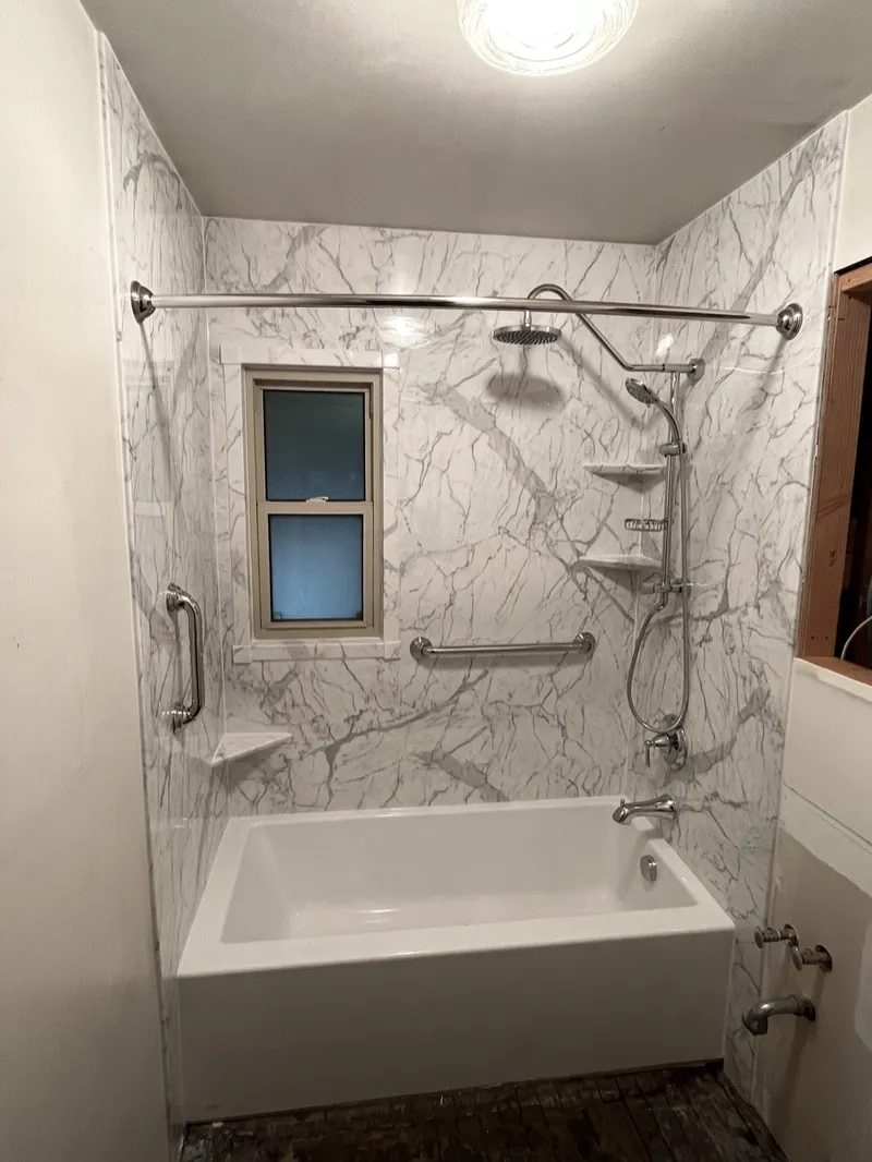 Tub surround with grab bars