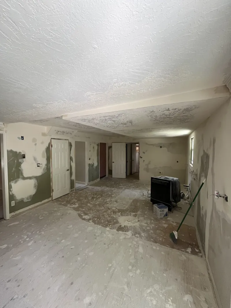 Basement room with old flooring removed down to the concrete