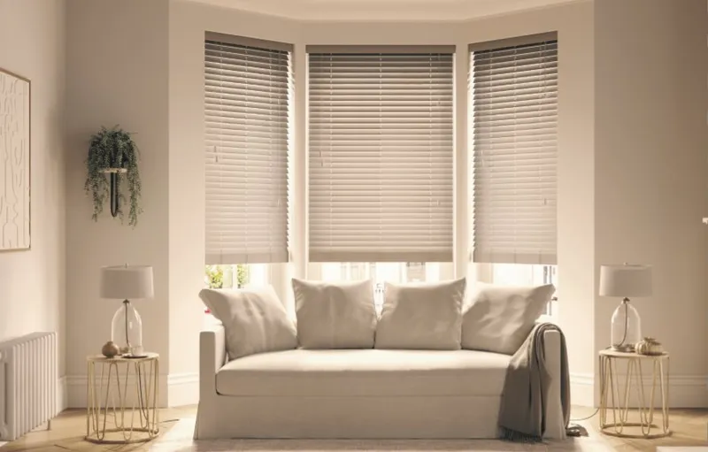 Faux wood venetian blinds across a bay window in a living room, Eclipse SBC serving Lincoln