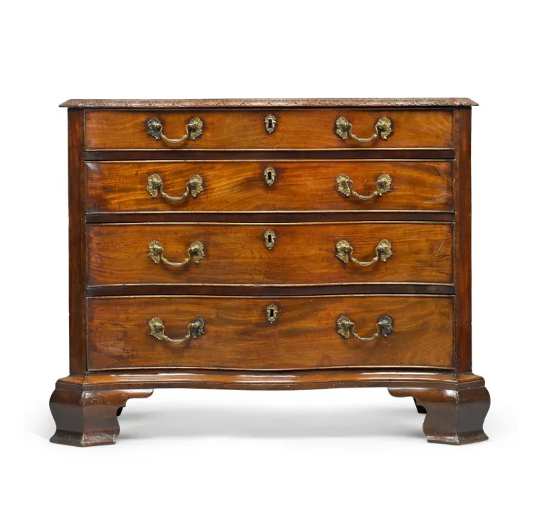 A George III carved mahogany serpentine chest of drawers, Circa 1765, in the manner of Philip Bell
