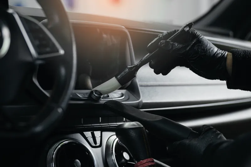 Detailing brush cleaning a dashboard console