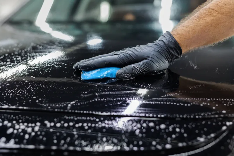 Clay bar decontaminating wet black paint