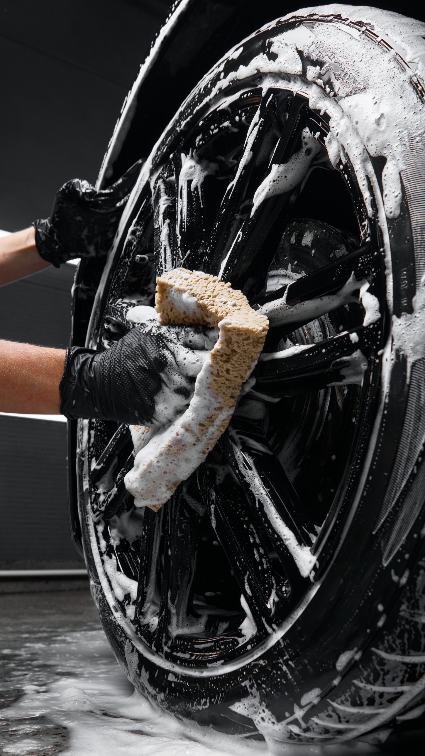 Hand washing a foamed black wheel