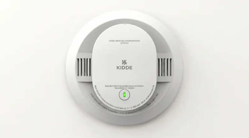 Combination smoke and carbon monoxide alarm mounted on a ceiling