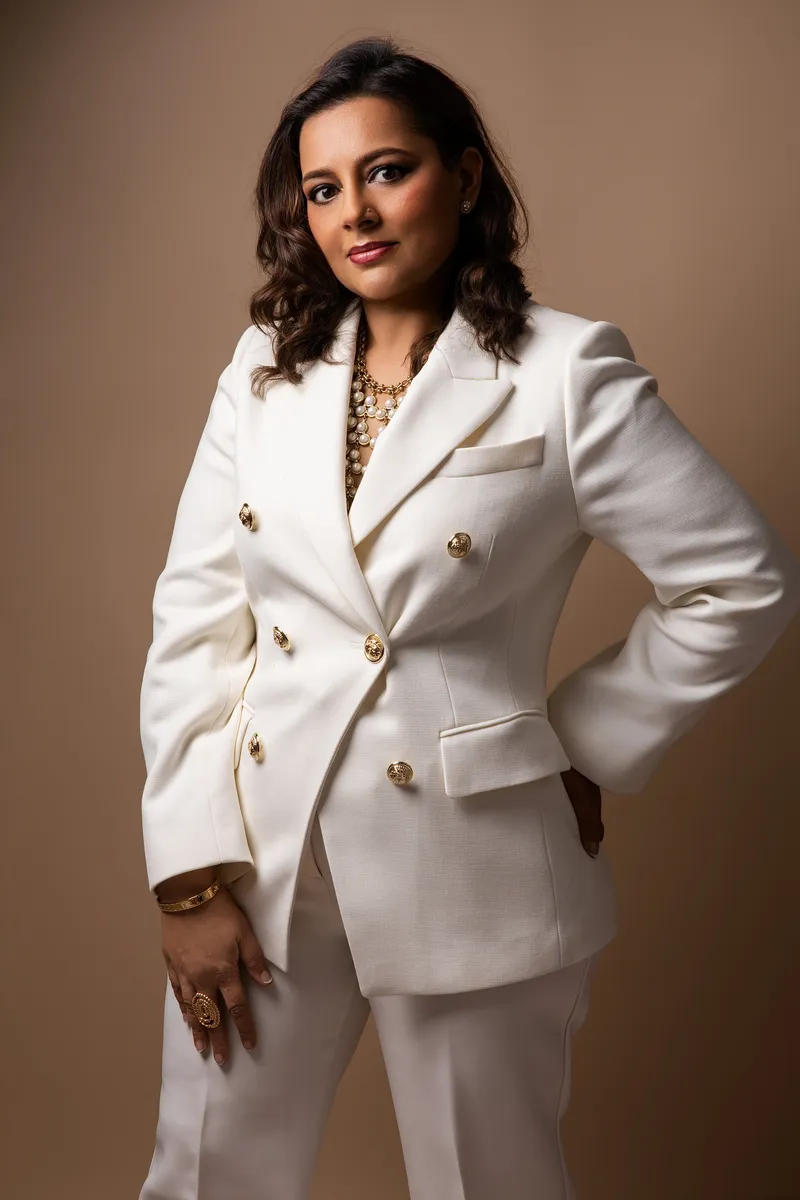 Dr Ricky Ghataura in a white suit