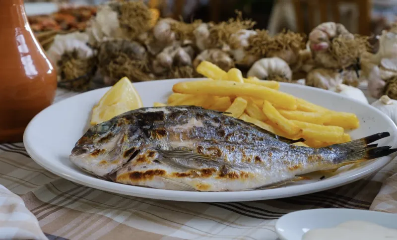 Fresh local Tsipoura on the grill (sea bream)