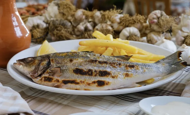 Fresh local Lavraki on the grill (sea bass)
