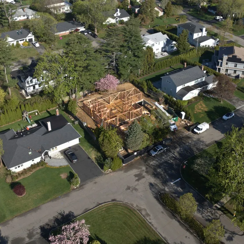 Mill Neck Renovation: aerial of the home framed and under construction on its street