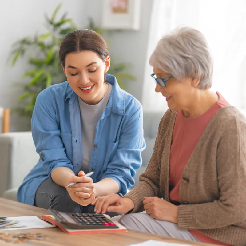 Joni reviewing Medicare plan options with a client at her kitchen table