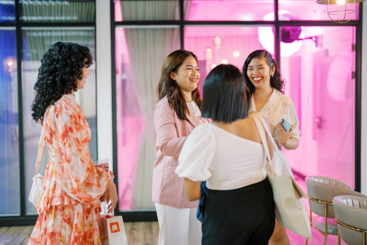 FWIB members laughing as they greet each other
