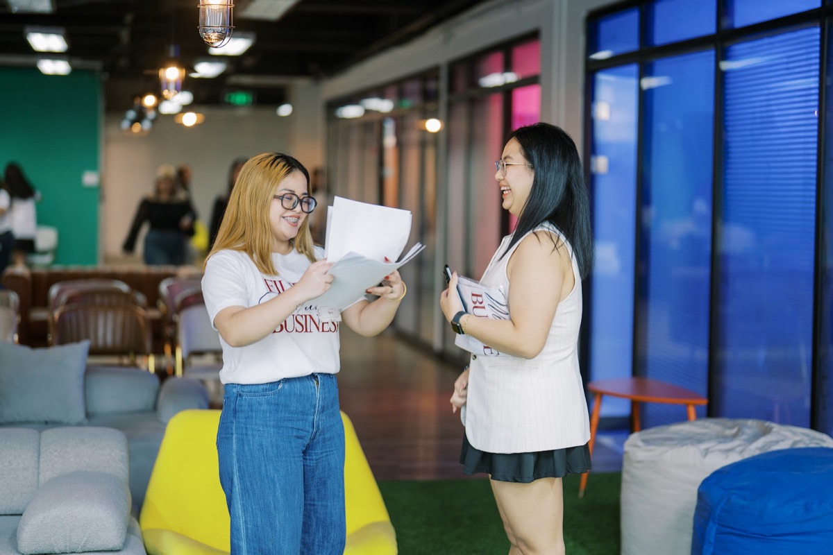 Two FWIB members laughing mid-conversation