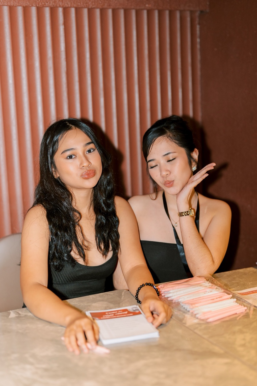 Two FWIB members being playful at the registration table