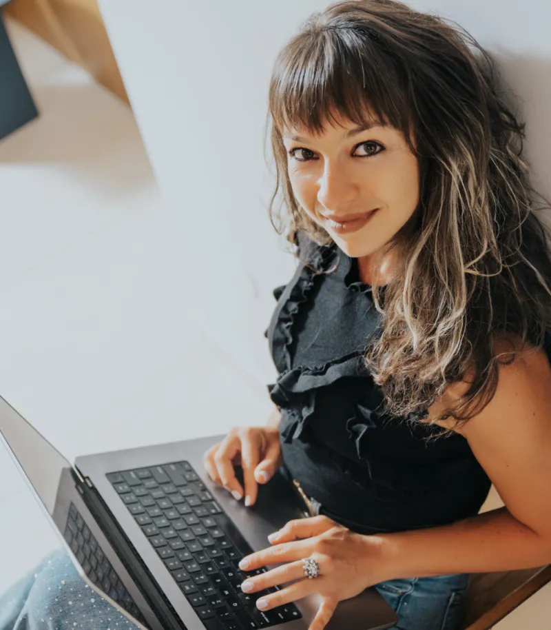 Marchela working at her laptop