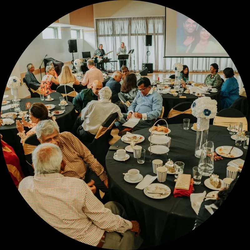 Guests seated at round tables at a catered event