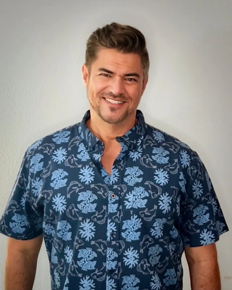 Michael Hanle, smiling, in a blue aloha shirt