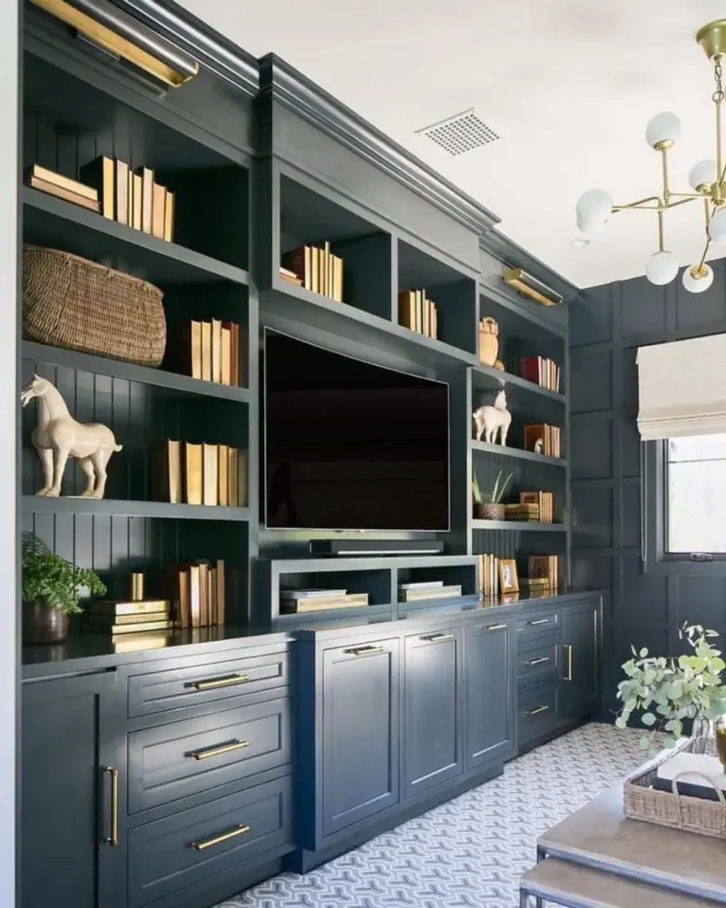 Dark painted built-in shelving and cabinets