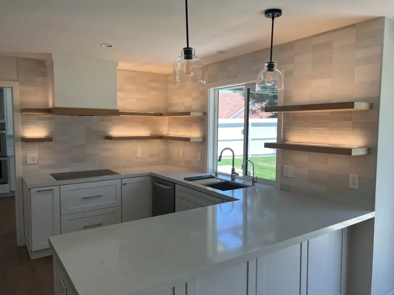 White kitchen with lit shelves