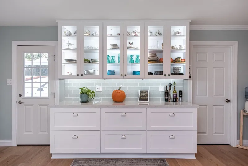 White hutch with lit glass-front upper cabinets