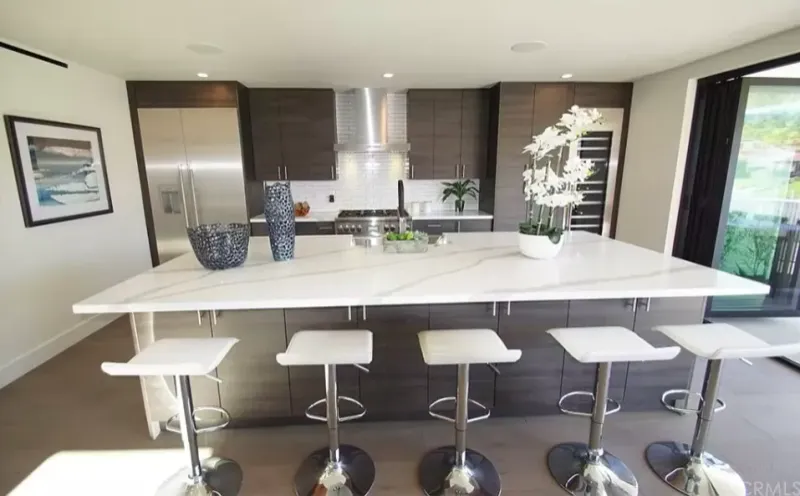 Modern kitchen with a white island and dark wood-grain cabinets