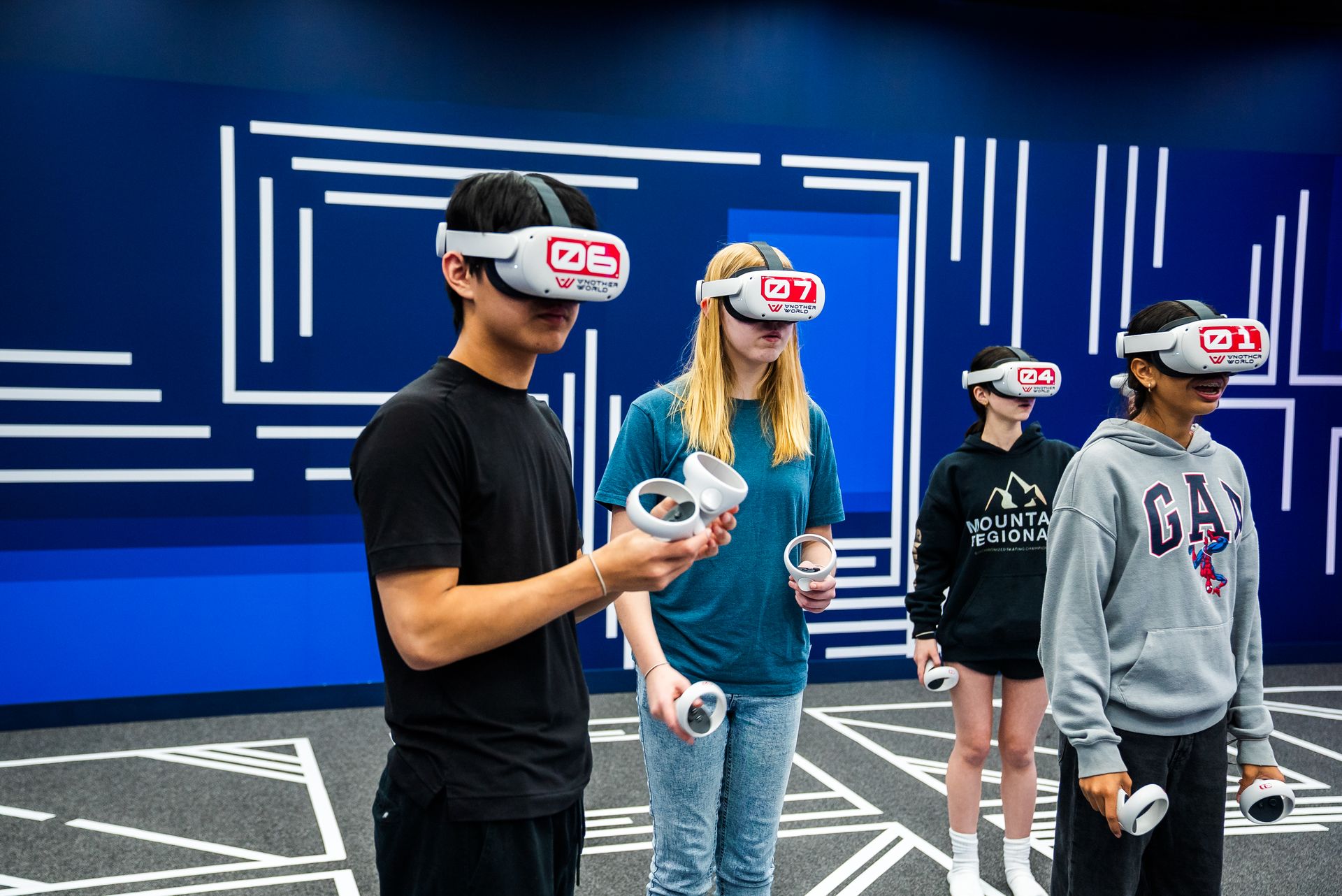 Four students in headsets holding controllers