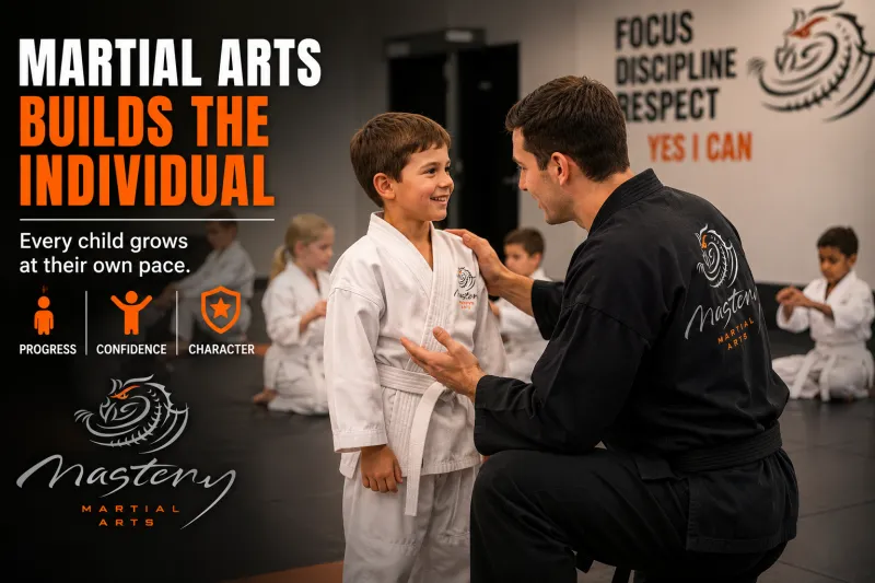 Young martial arts student earning individual instruction from an instructor.