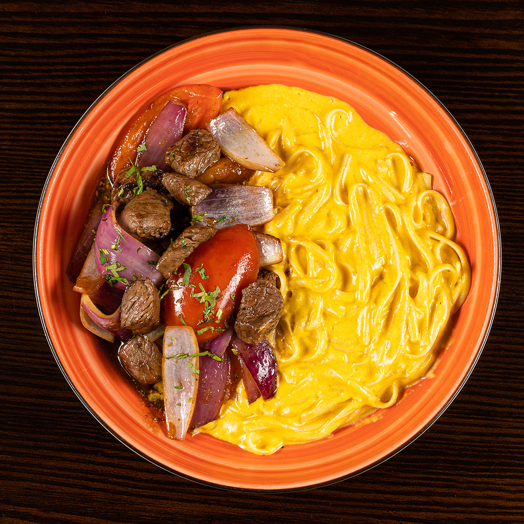 Pasta Huancaina with Lomo Saltado 