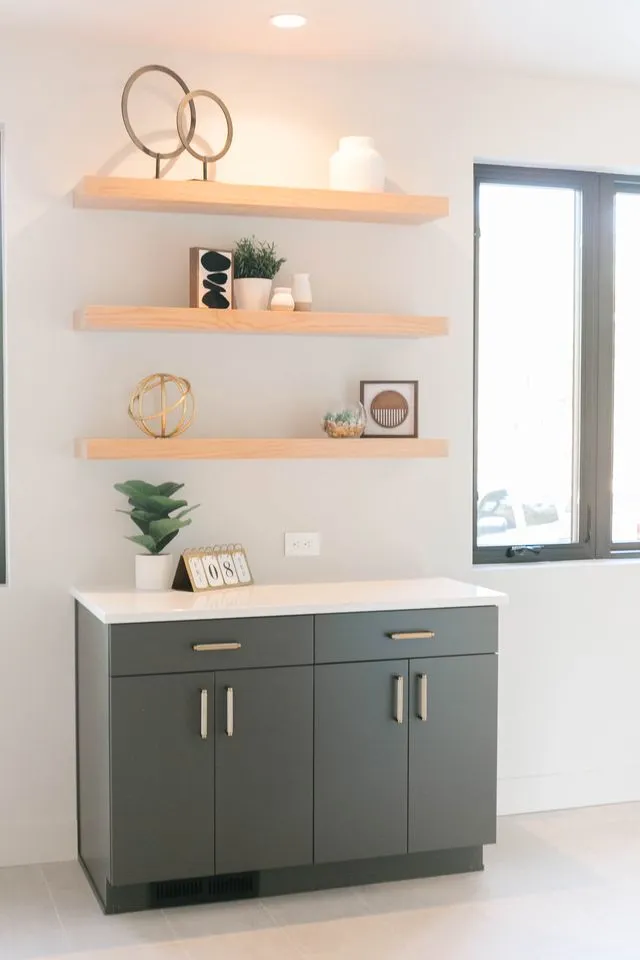 Dark gray flat-panel cabinet with floating wood shelves above