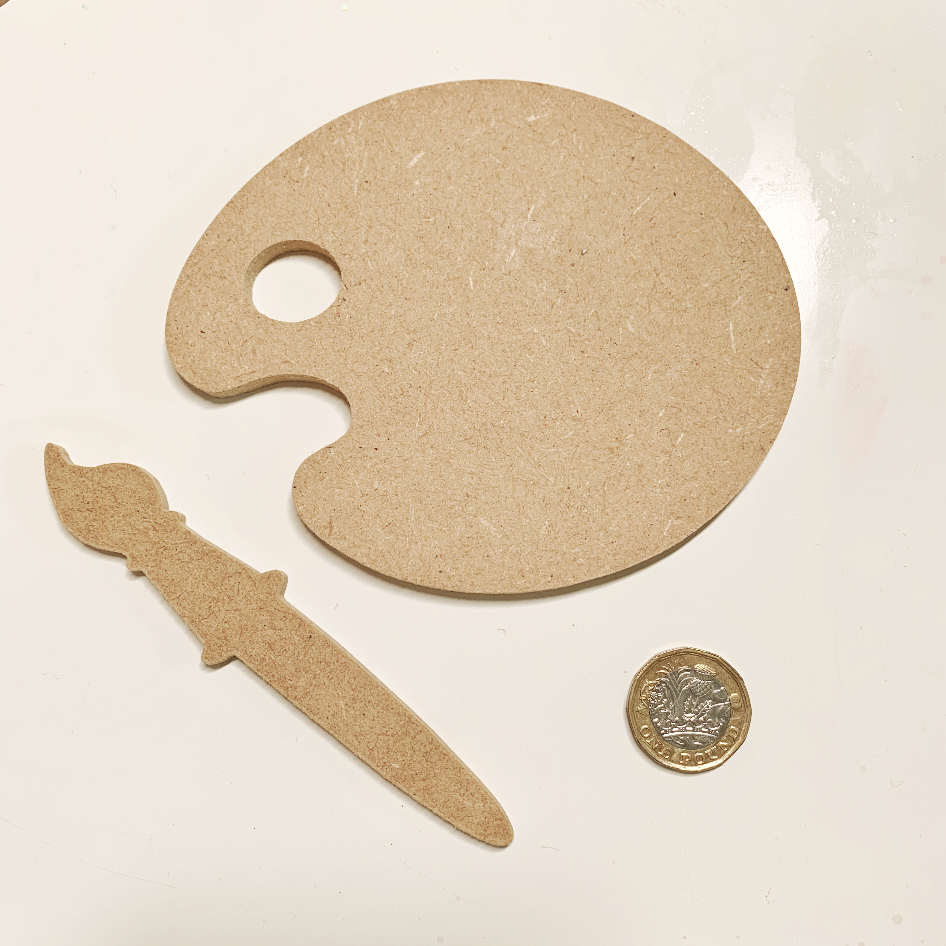 Blank wooden paint palette and brush
