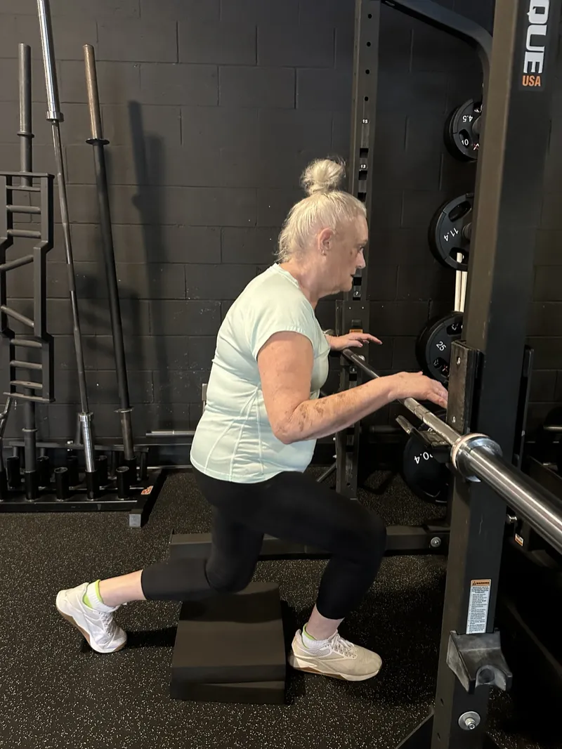 Client doing a supported split squat at the rack