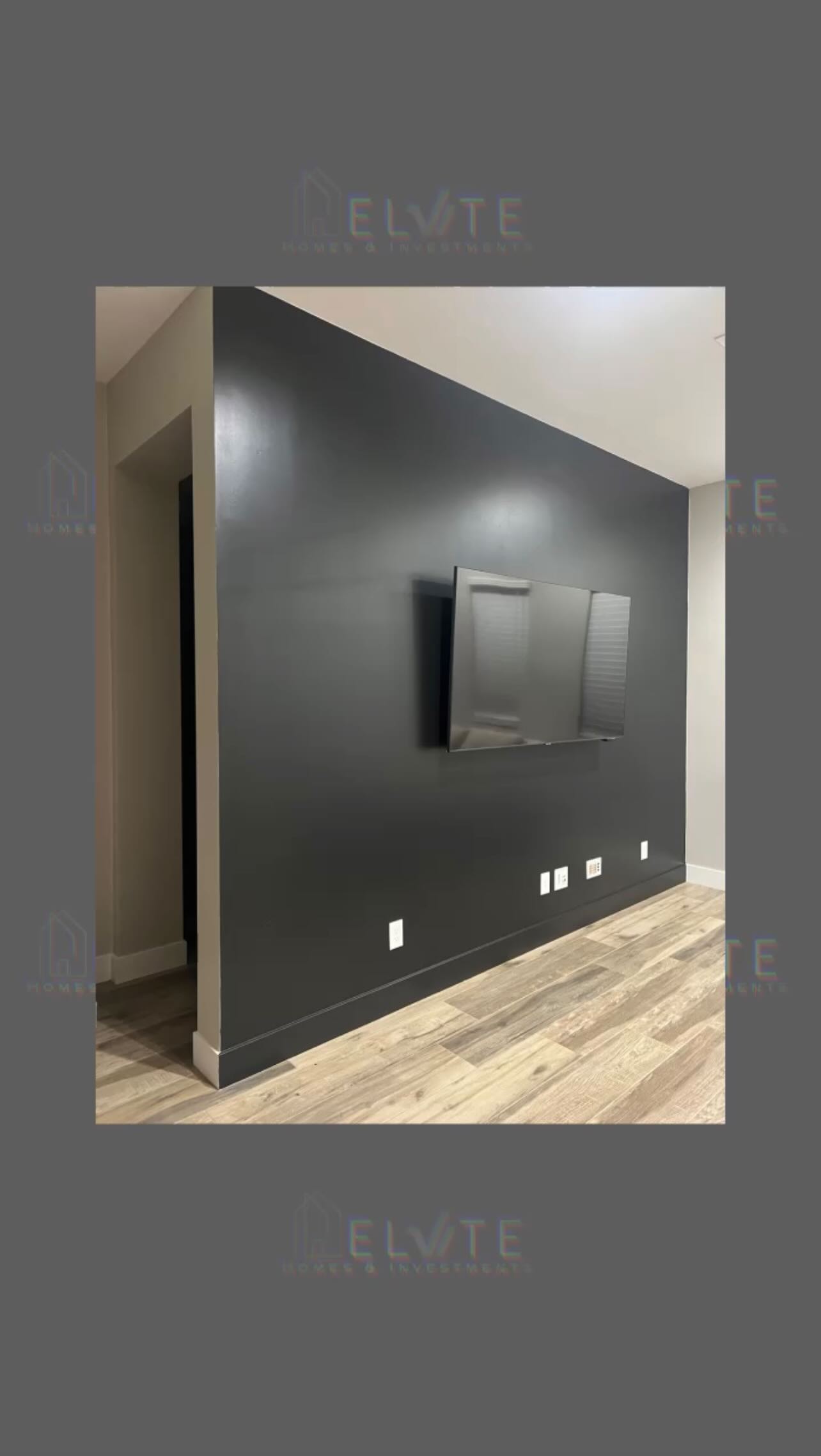 Dark interior accent wall with TV and hardwood floor Mesa AZ