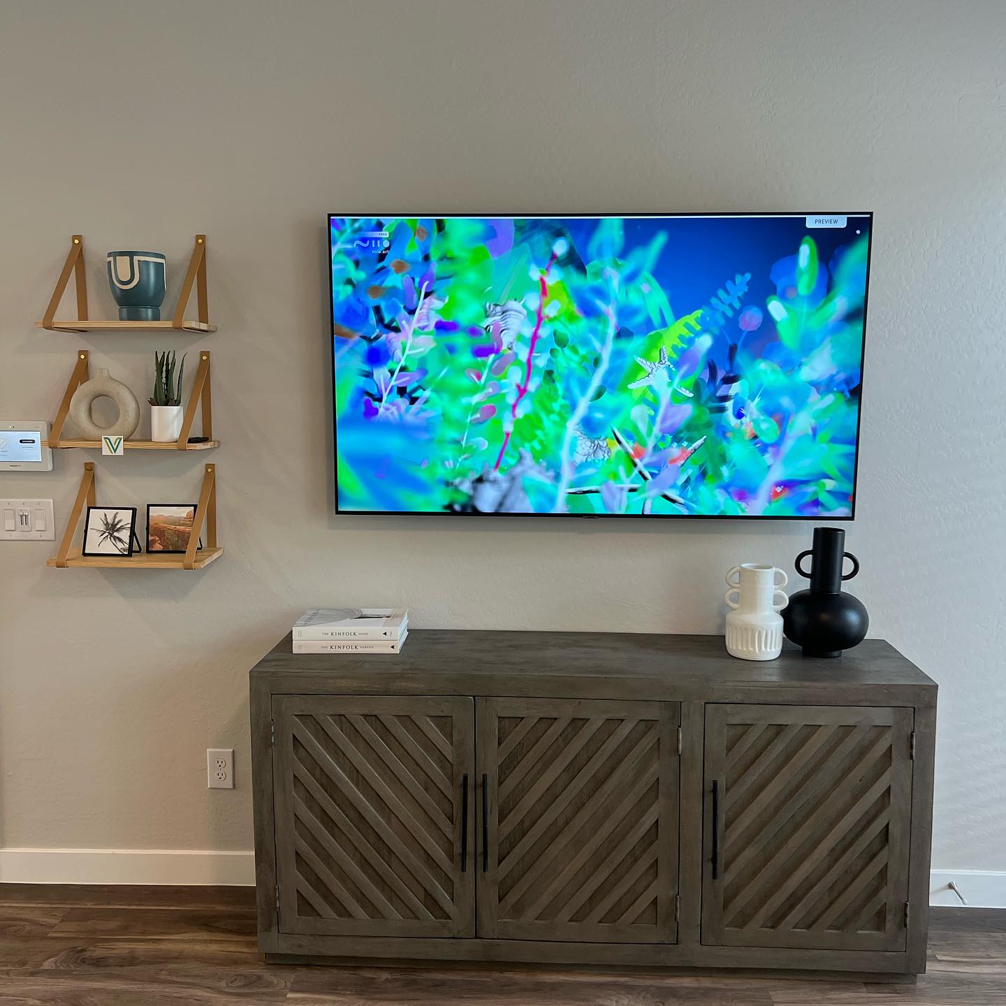 Renovated living room with floating shelves and TV Phoenix AZ