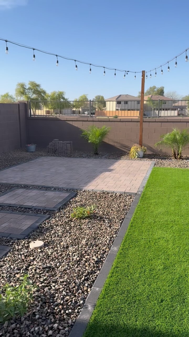 Backyard paver patio with string lights and turf Scottsdale AZ