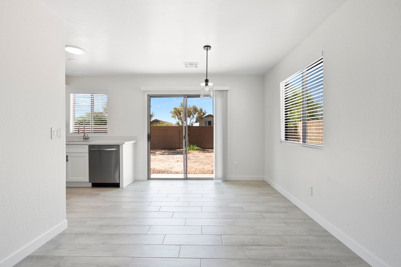 Open living and kitchen space with gray wood-look tile flooring — flooring installation Phoenix AZ