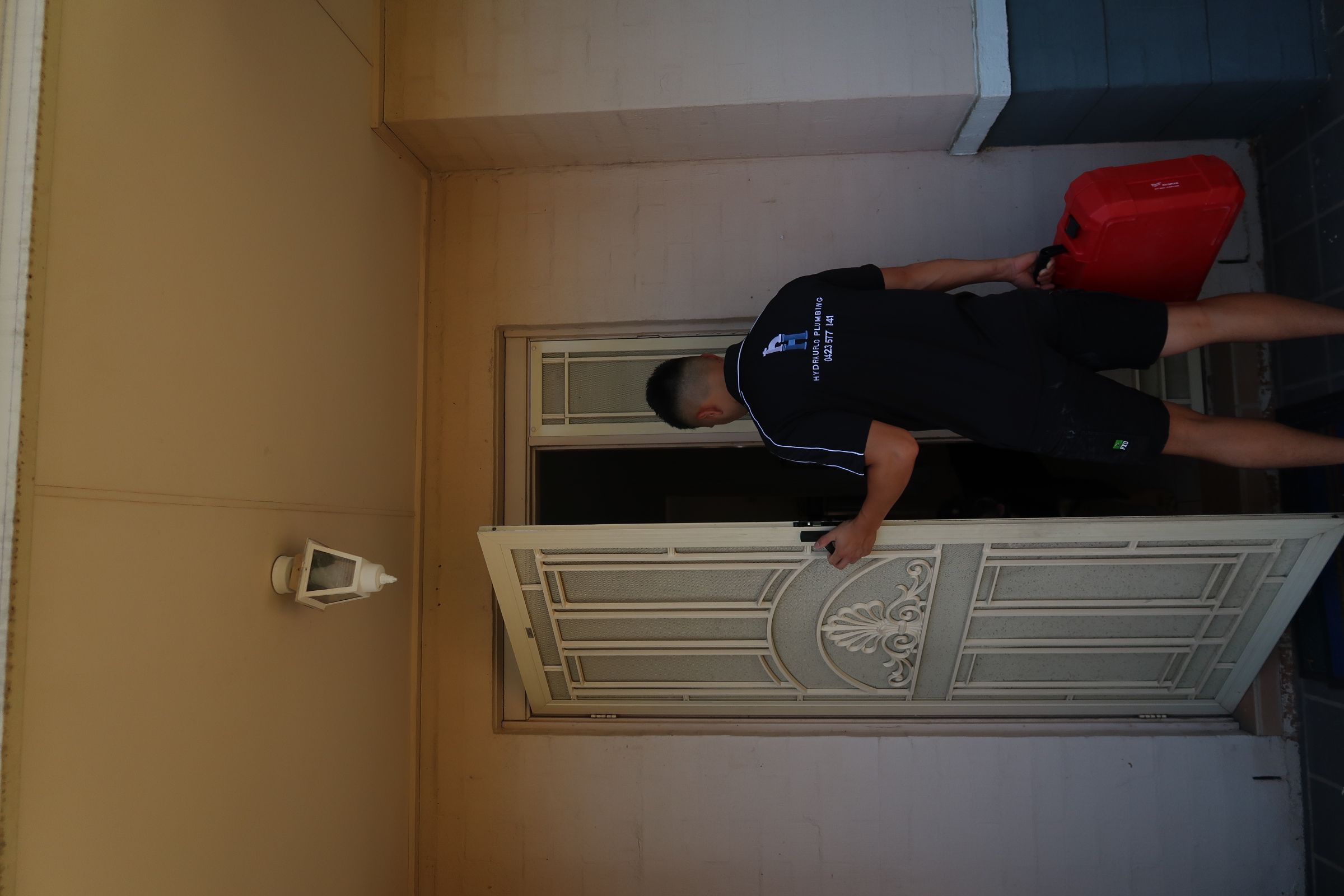Hydrauflo plumber arriving at a home carrying a tool case