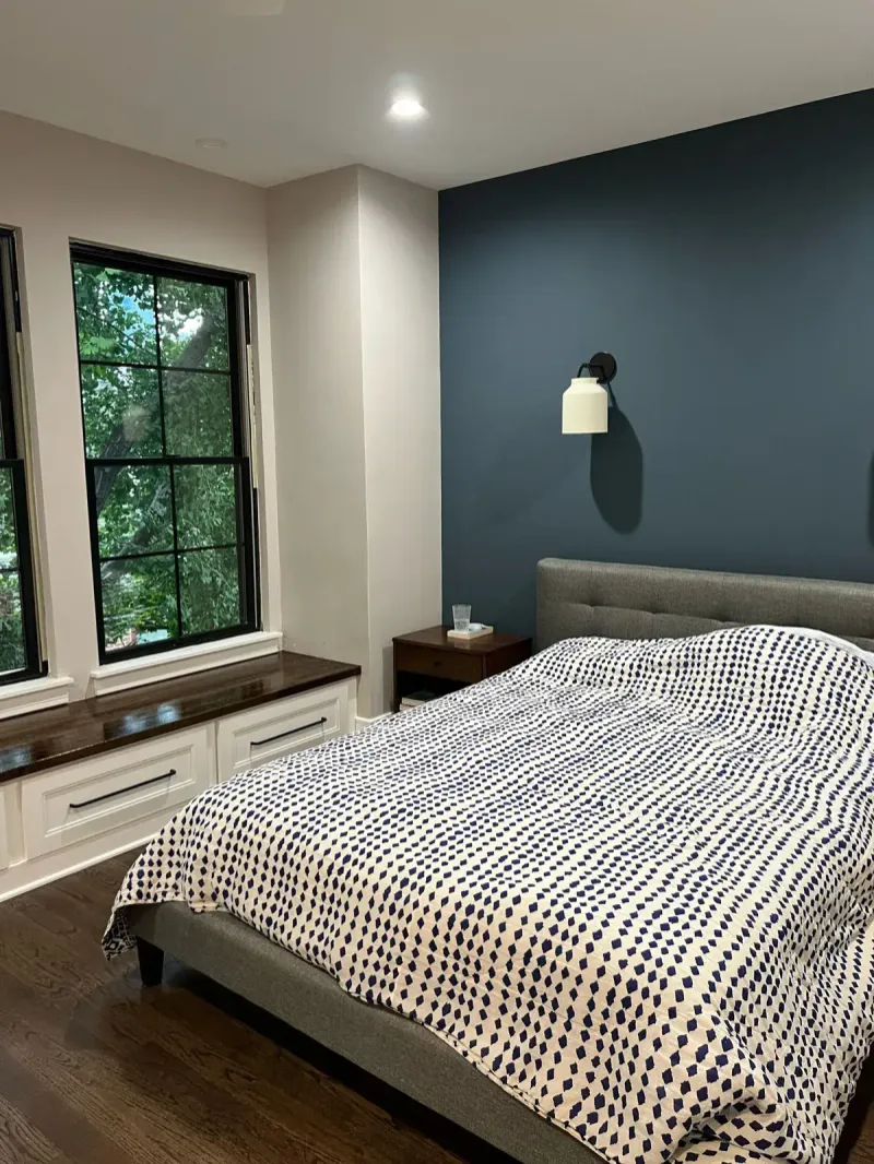 Bedroom with navy accent wall and custom window bench