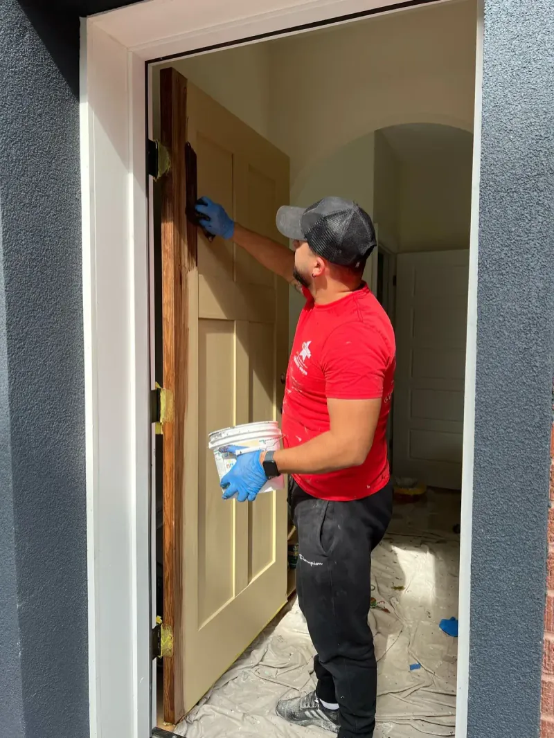 WN Painting & Remodeling painter refinishing an interior door in a Philadelphia home