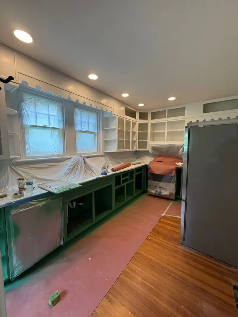 Kitchen cabinets masked and prepped before painting