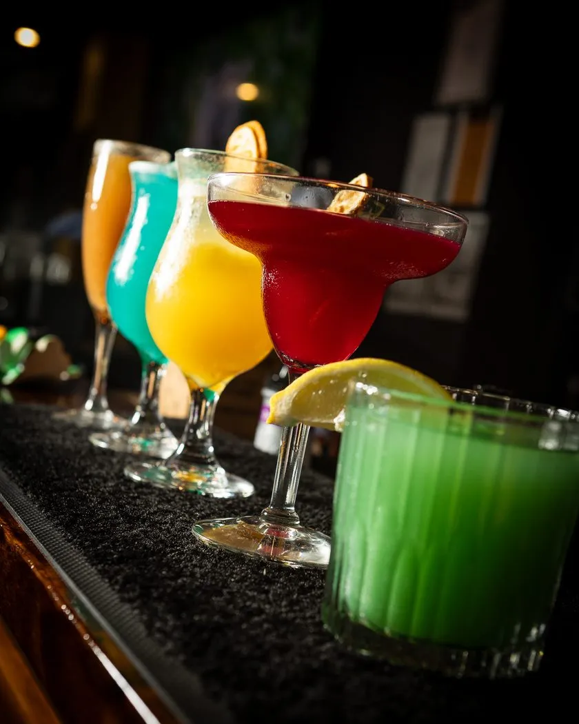 Colourful cocktails and mocktails lined up on the bar