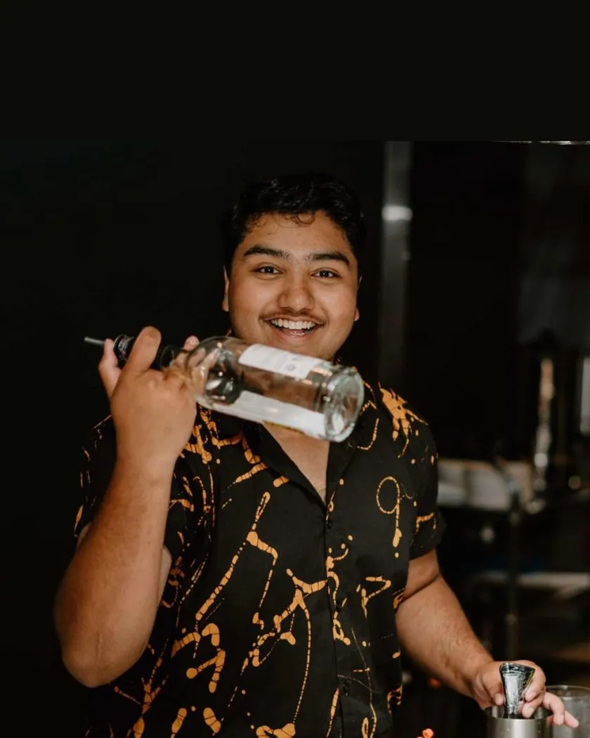 Bartender with a cocktail shaker behind the bar