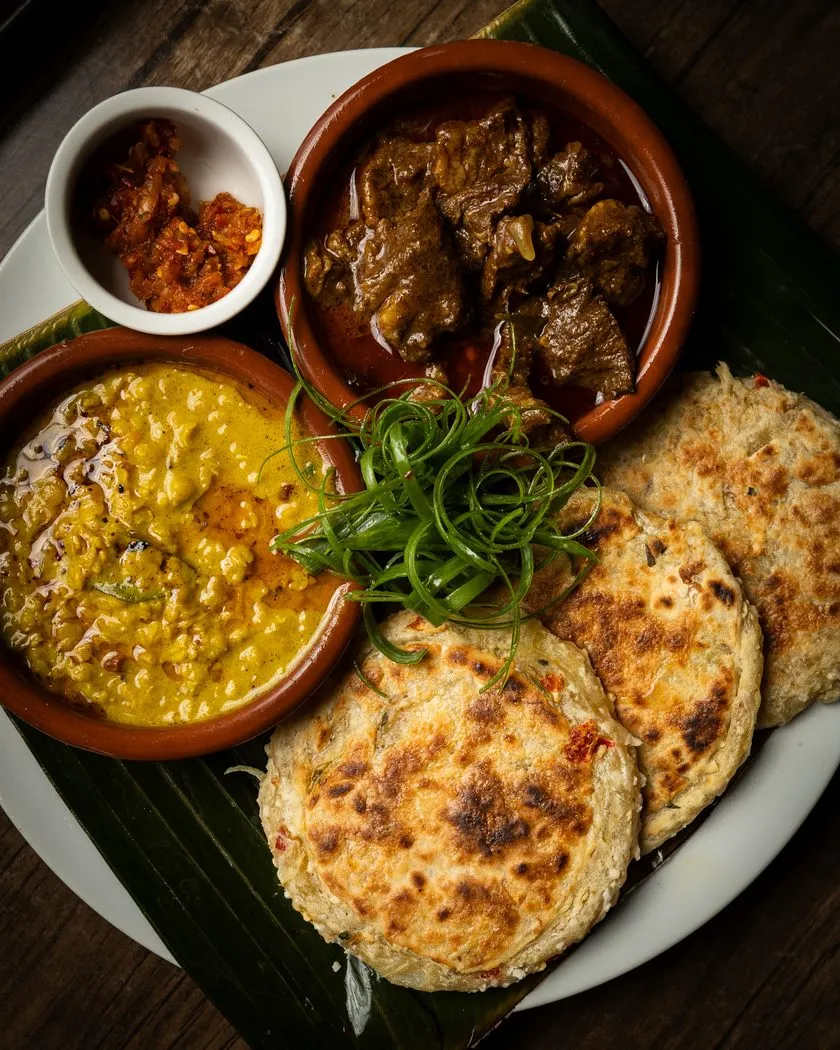 Coconut roti with dhal curry, meat curry and lunu miris